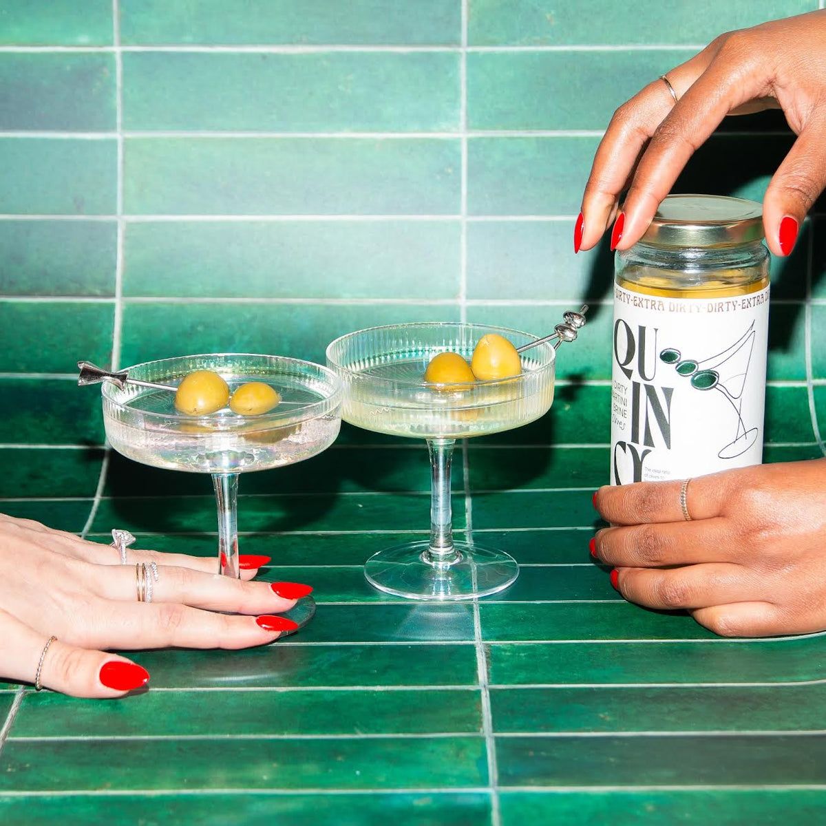 two martini glasses with jar of Quincy
